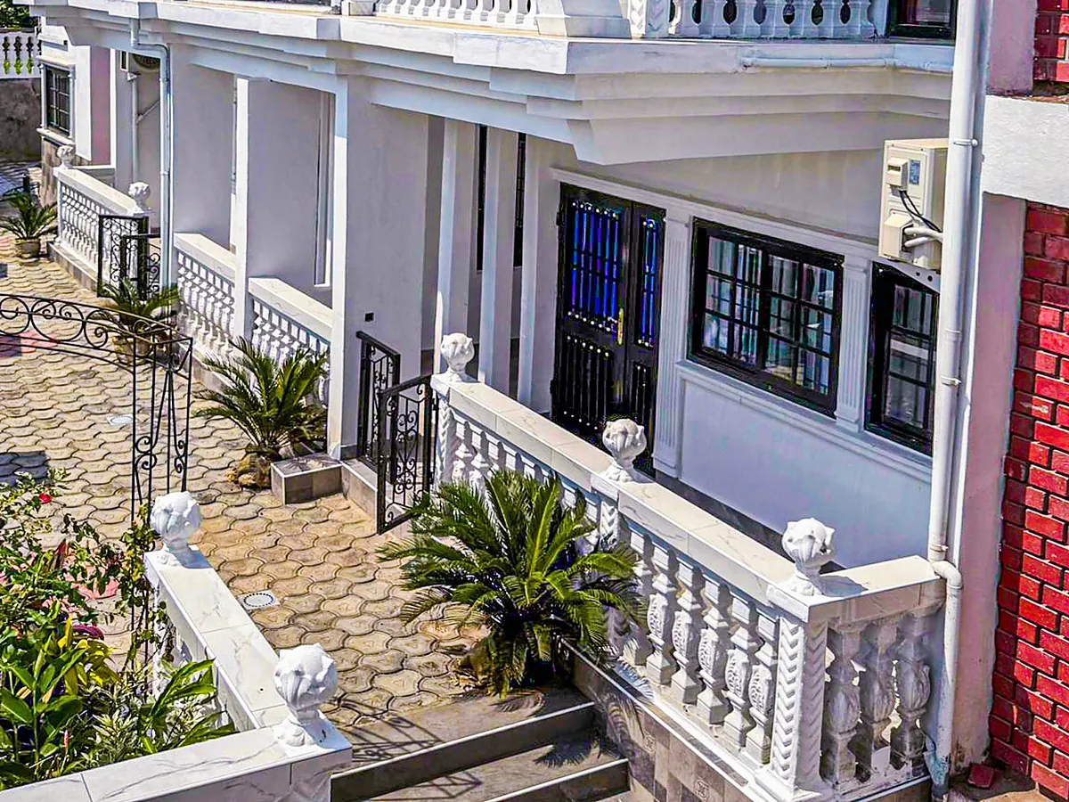 Wrought-iron gate and covered walkway