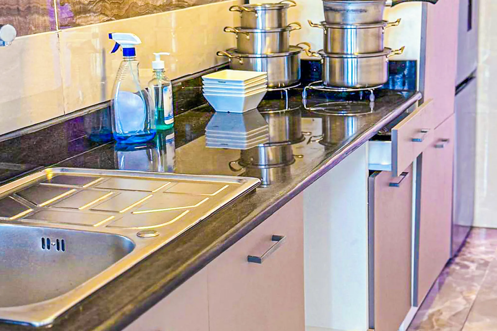 Kitchen with induction hob and refrigerator