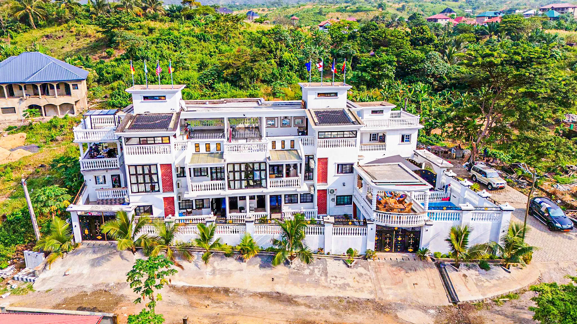 Aerial view of Sky Guest House in Limbola, Limbe, with the rooftop pool and the surrounding hills