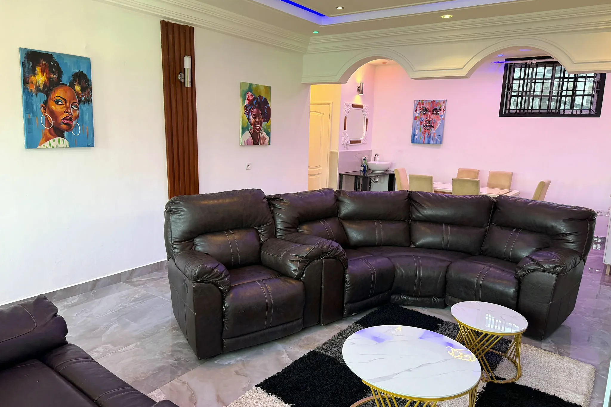 Living area with sofas, artwork and a view through to the kitchen
